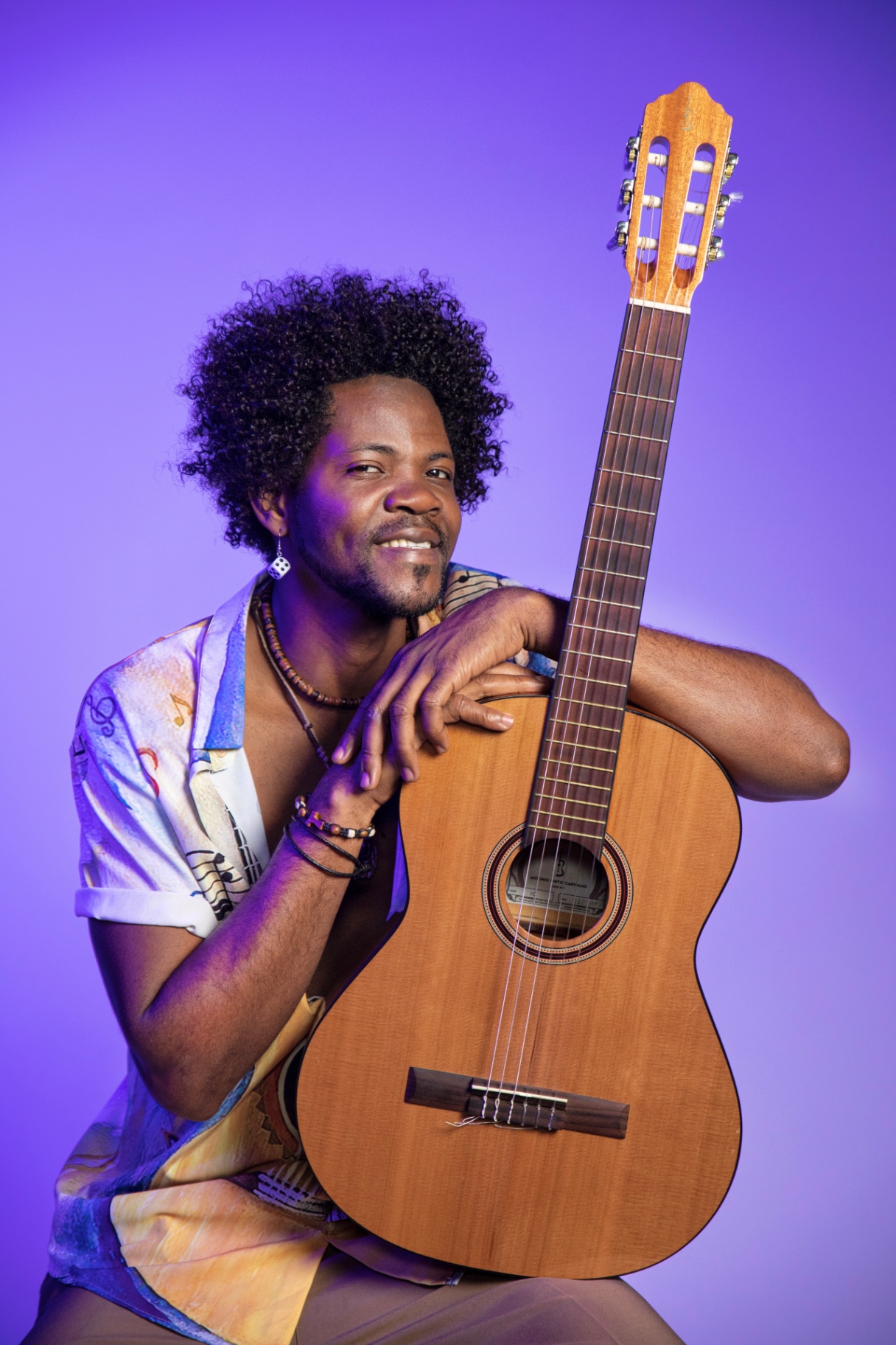 Studio portrait with classical guitar — purple light