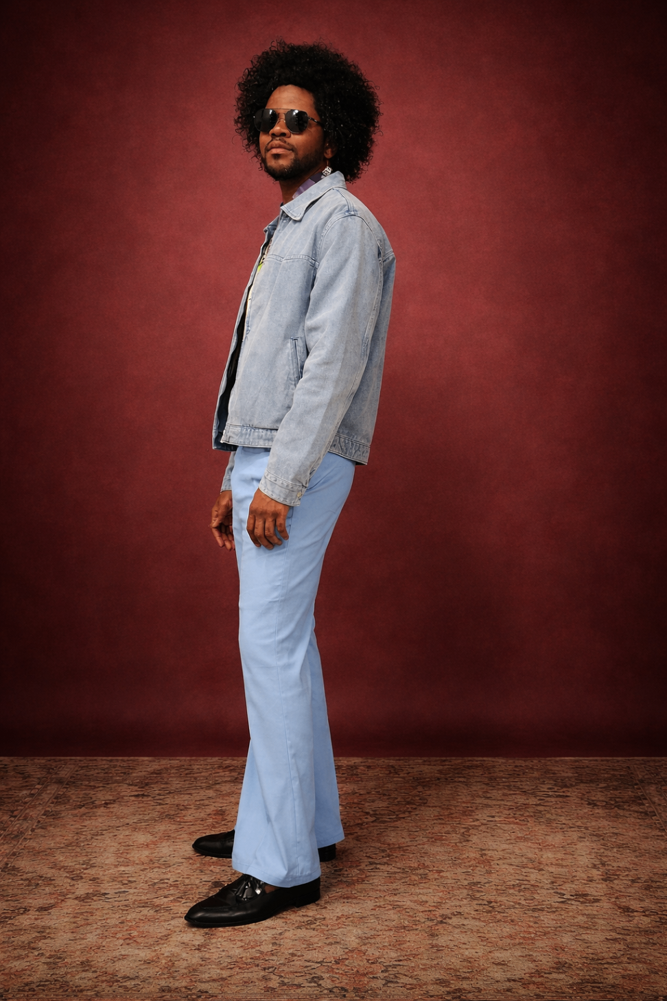 Editorial portrait — denim jacket on red backdrop